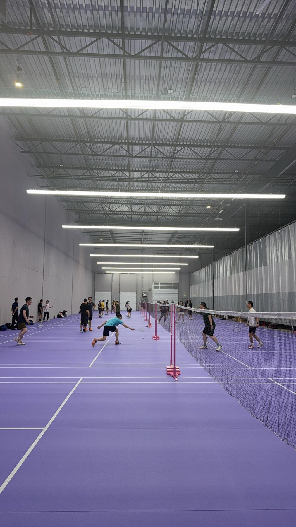 Canada badminton court player angle view under Huasport anti-glare fixtures