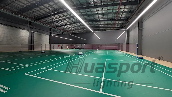 Long-bar Huasport badminton court lighting rows installed above an Australia indoor court