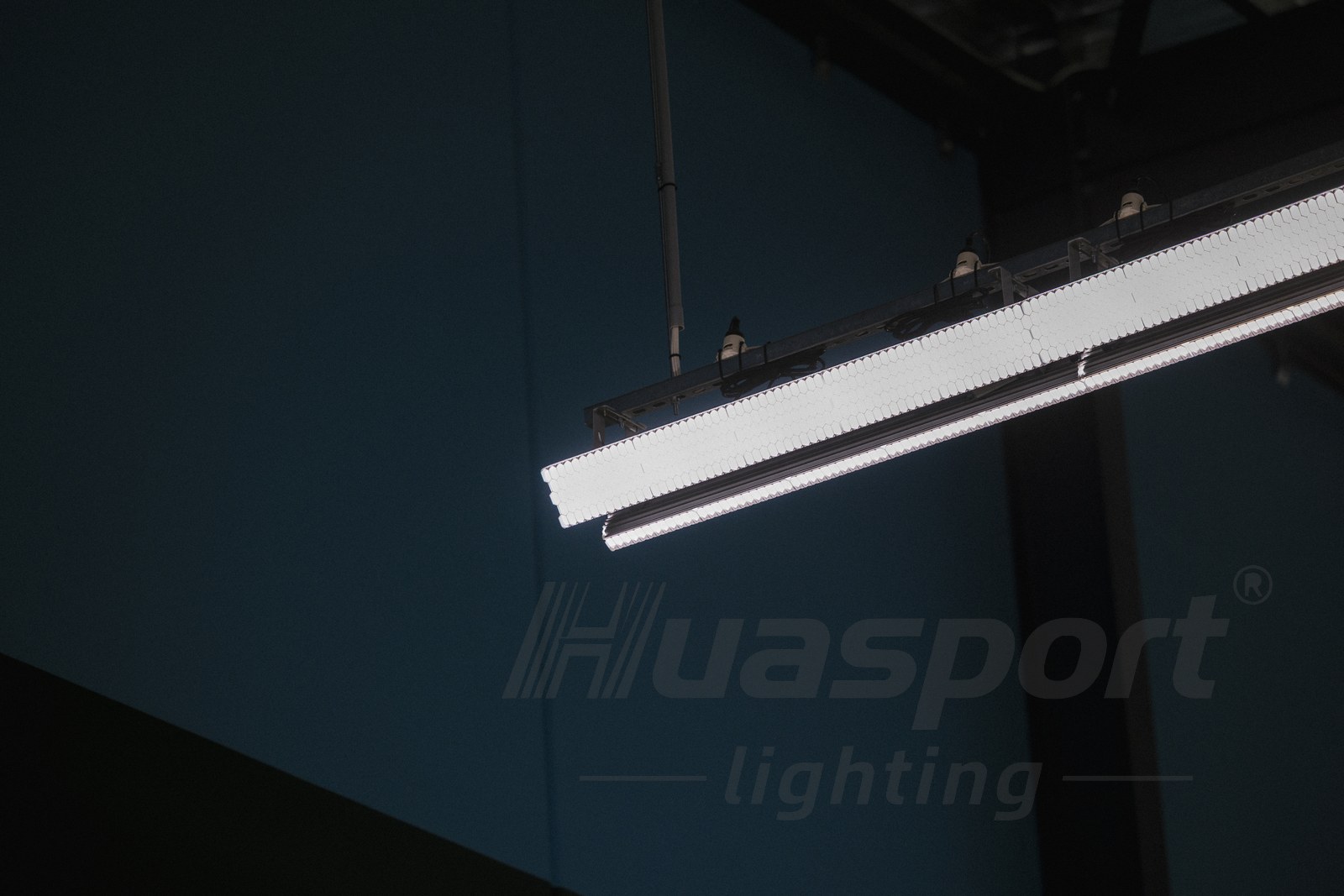 Close-up of long-bar Huasport badminton court lighting fixture installed in an Australia hall