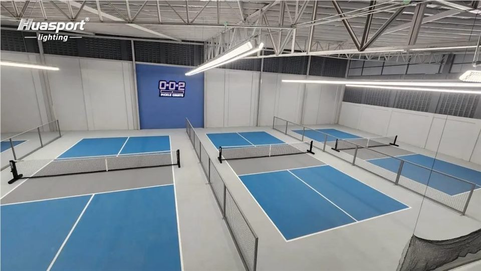 Indoor badminton and pickleball court lighting with Huasport S90 linear fixtures and Huasport logo