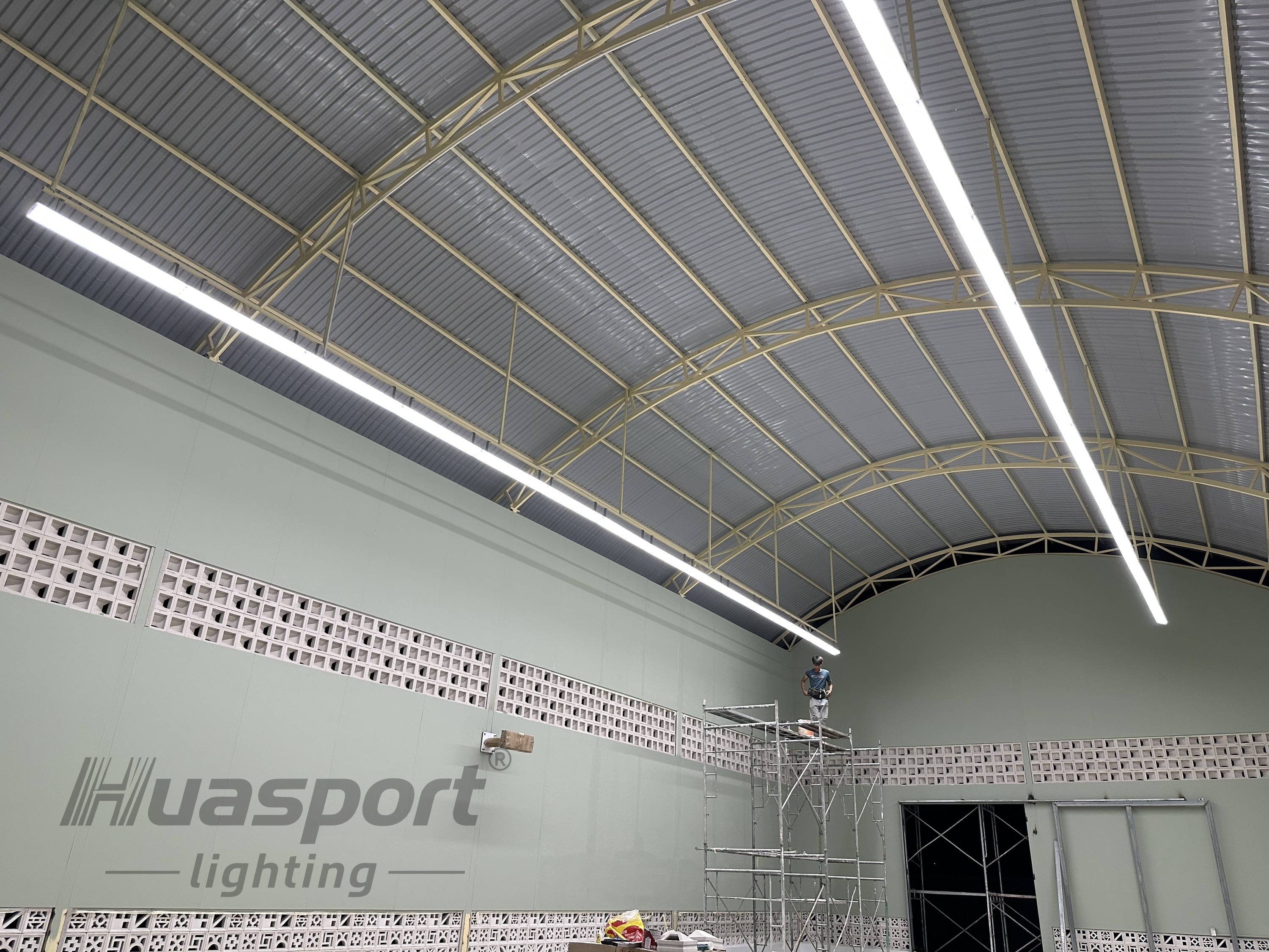 Southeast Asia indoor badminton court lighting installation reference with long-bar fixture rows at about 5 m height