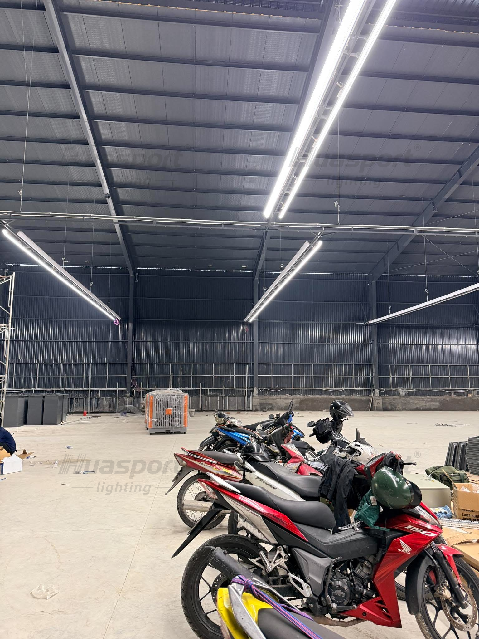Vietnam indoor badminton court lighting row direction with long-bar anti-glare fixtures before court finishing