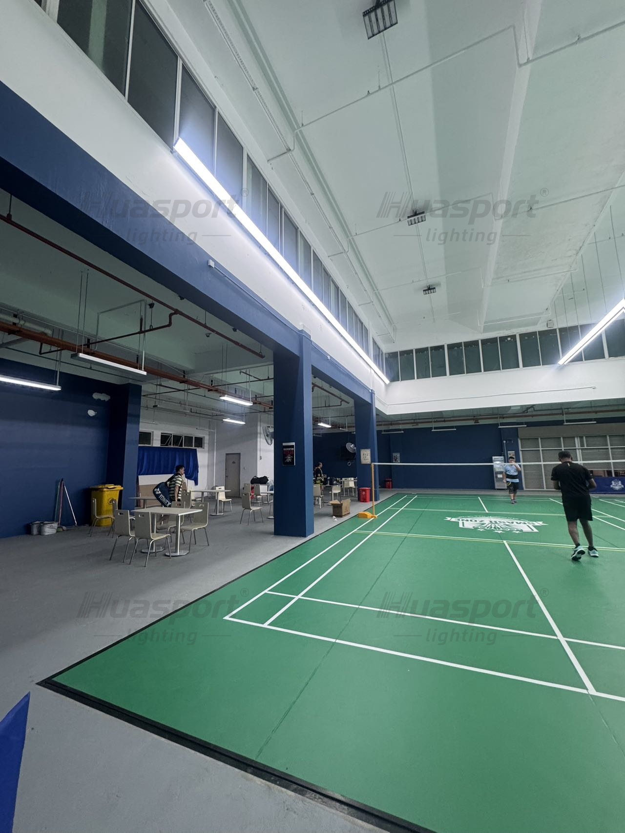 Brunei badminton court side-row lighting showing player view and long-bar anti-glare fixture direction