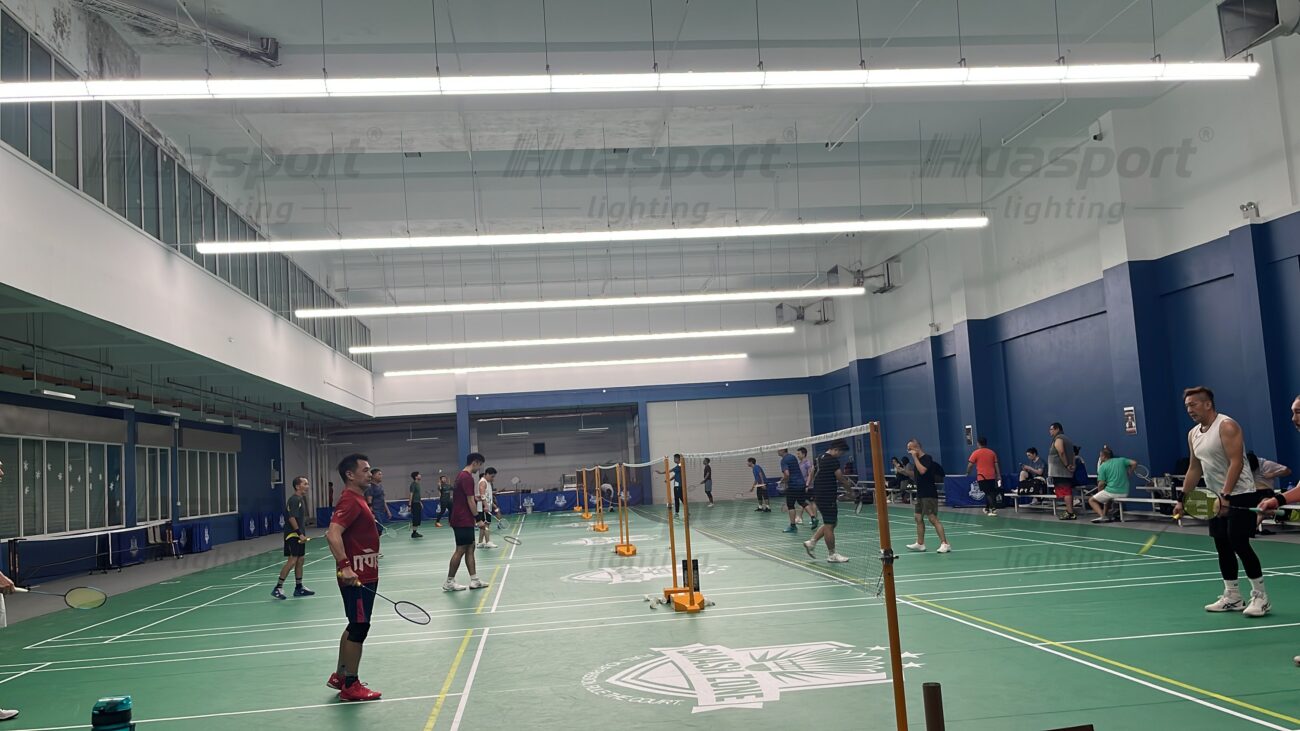 Brunei indoor badminton court lighting with Huasport long-bar anti-glare fixtures above multiple courts