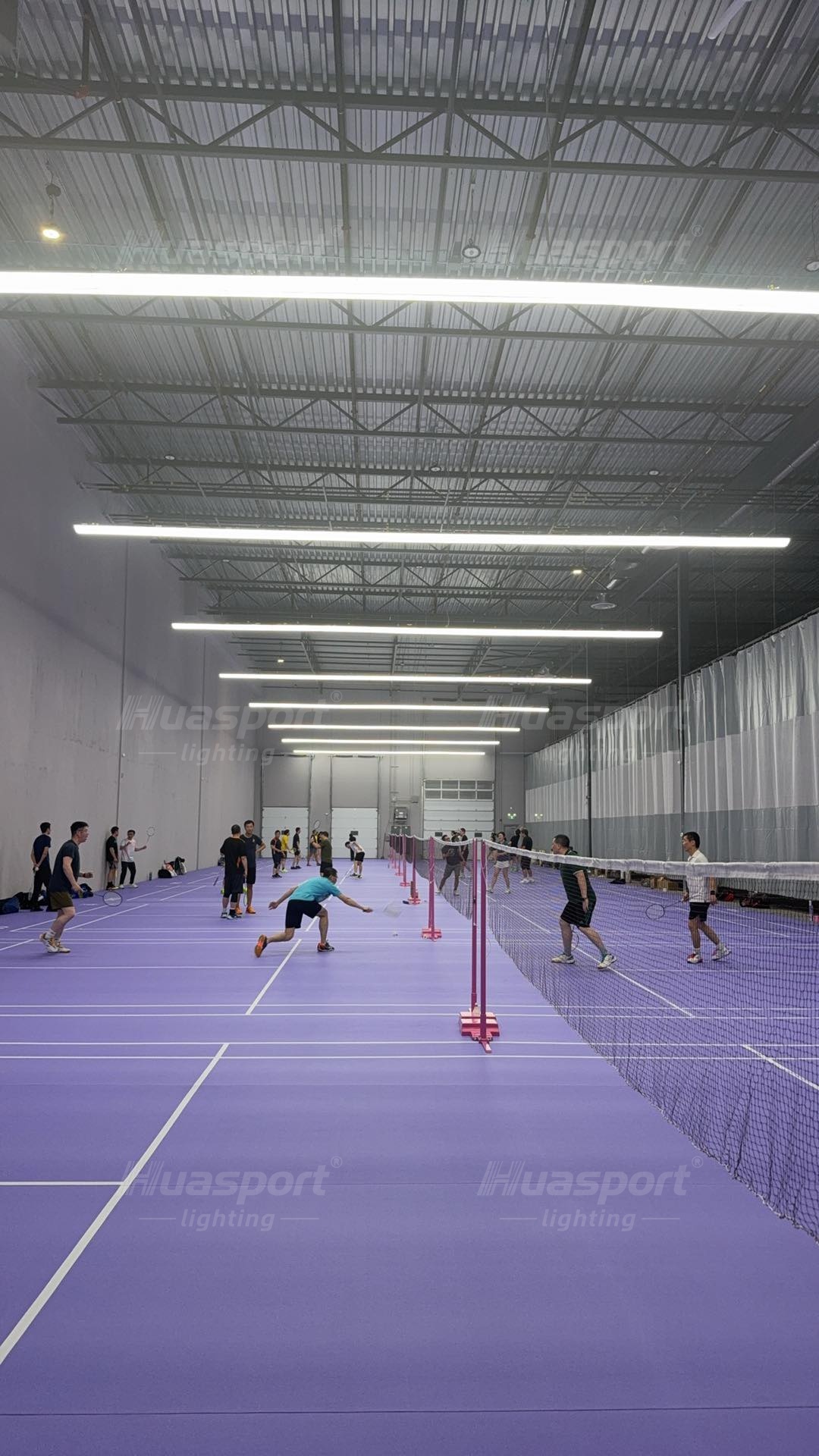 Canada badminton court lighting player view with long-bar rows above purple courts