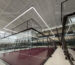 Indoor padel court lighting around glass walls using Huasport S70 long-bar anti-glare fixtures