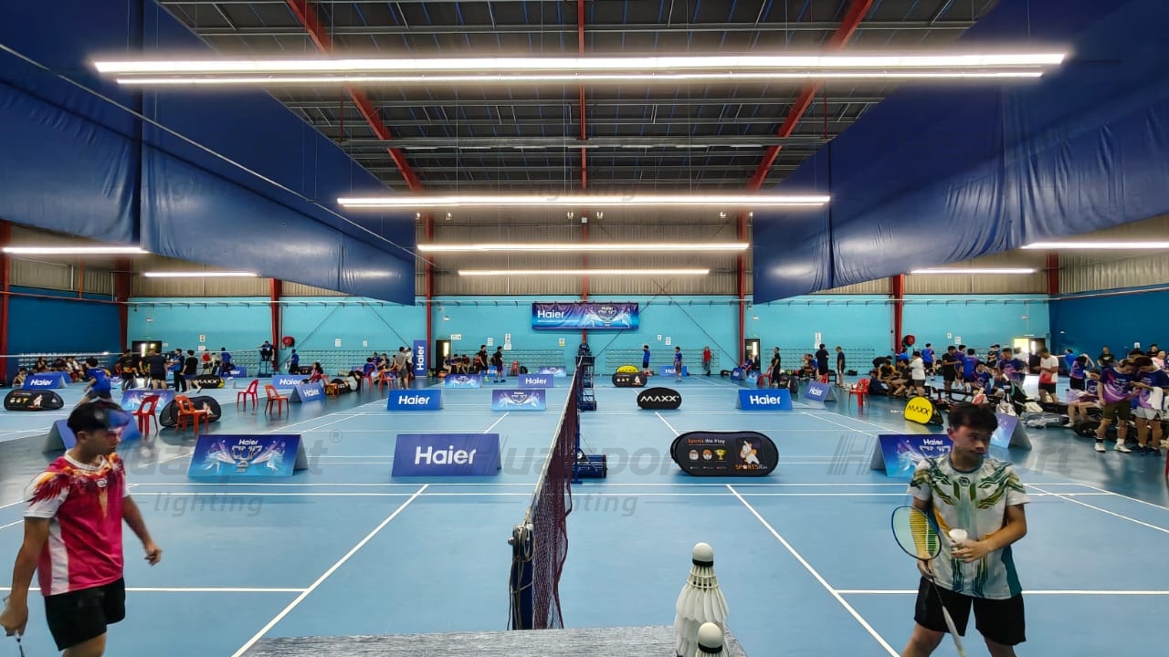 Malaysia badminton court side-row lighting showing player view and anti-glare long-bar fixture direction