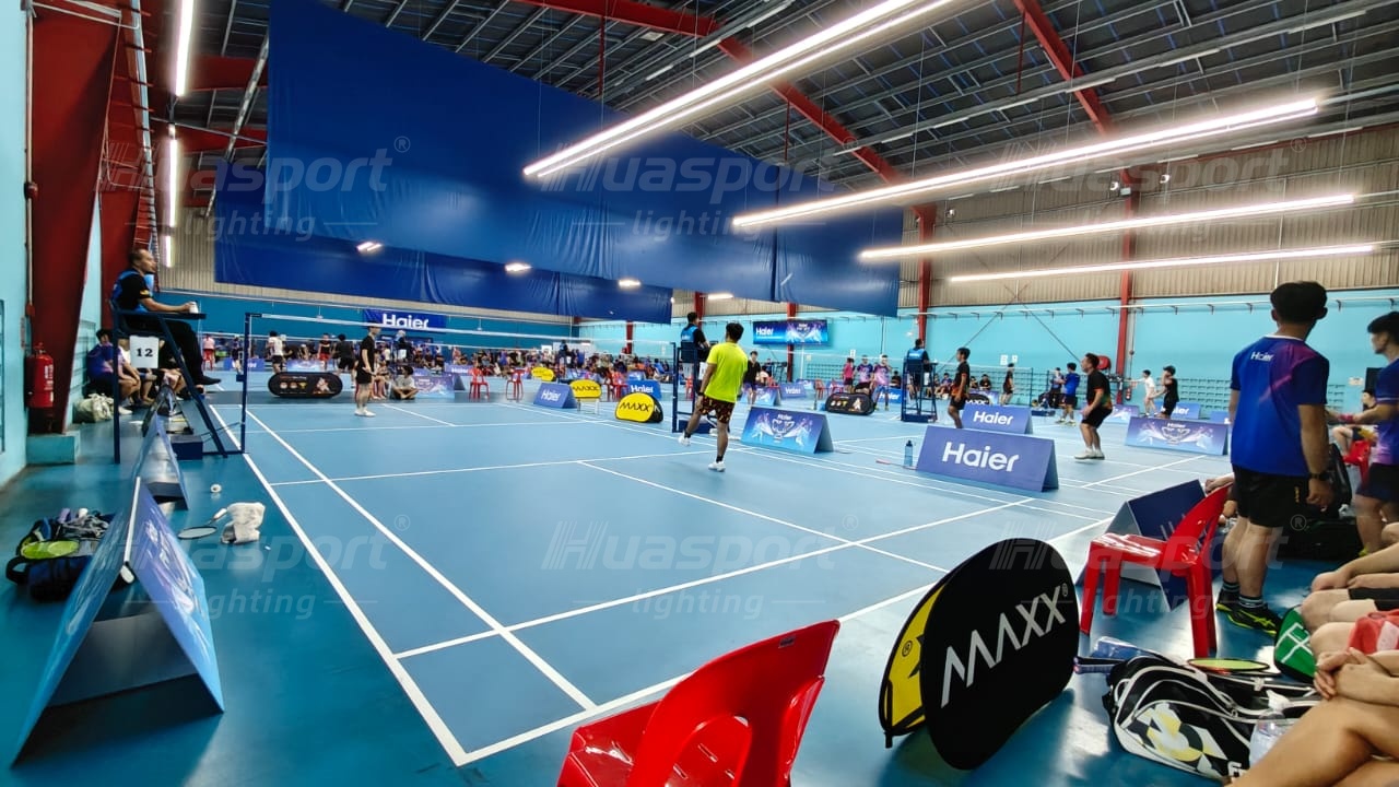 Malaysia badminton player-side glare check under long-bar court lighting rows