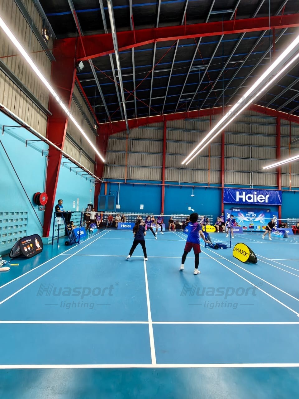 Malaysia badminton court player view with long-bar anti-glare lights above the court