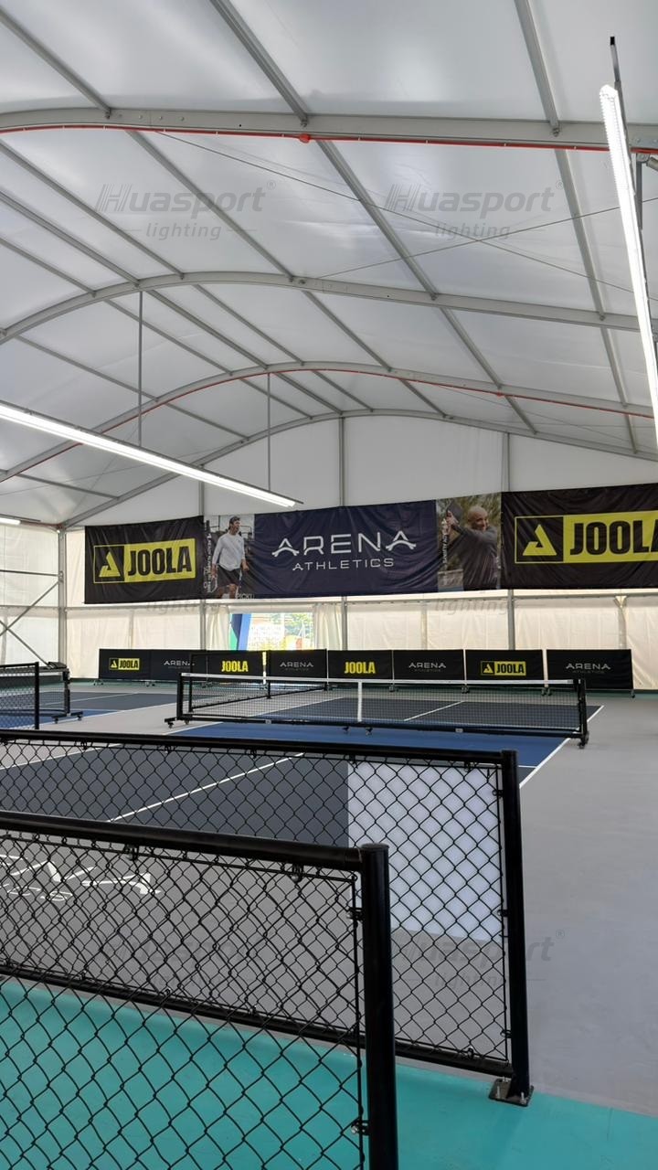 Philippines indoor pickleball courts with chain-link dividers and long-bar anti-glare lighting above