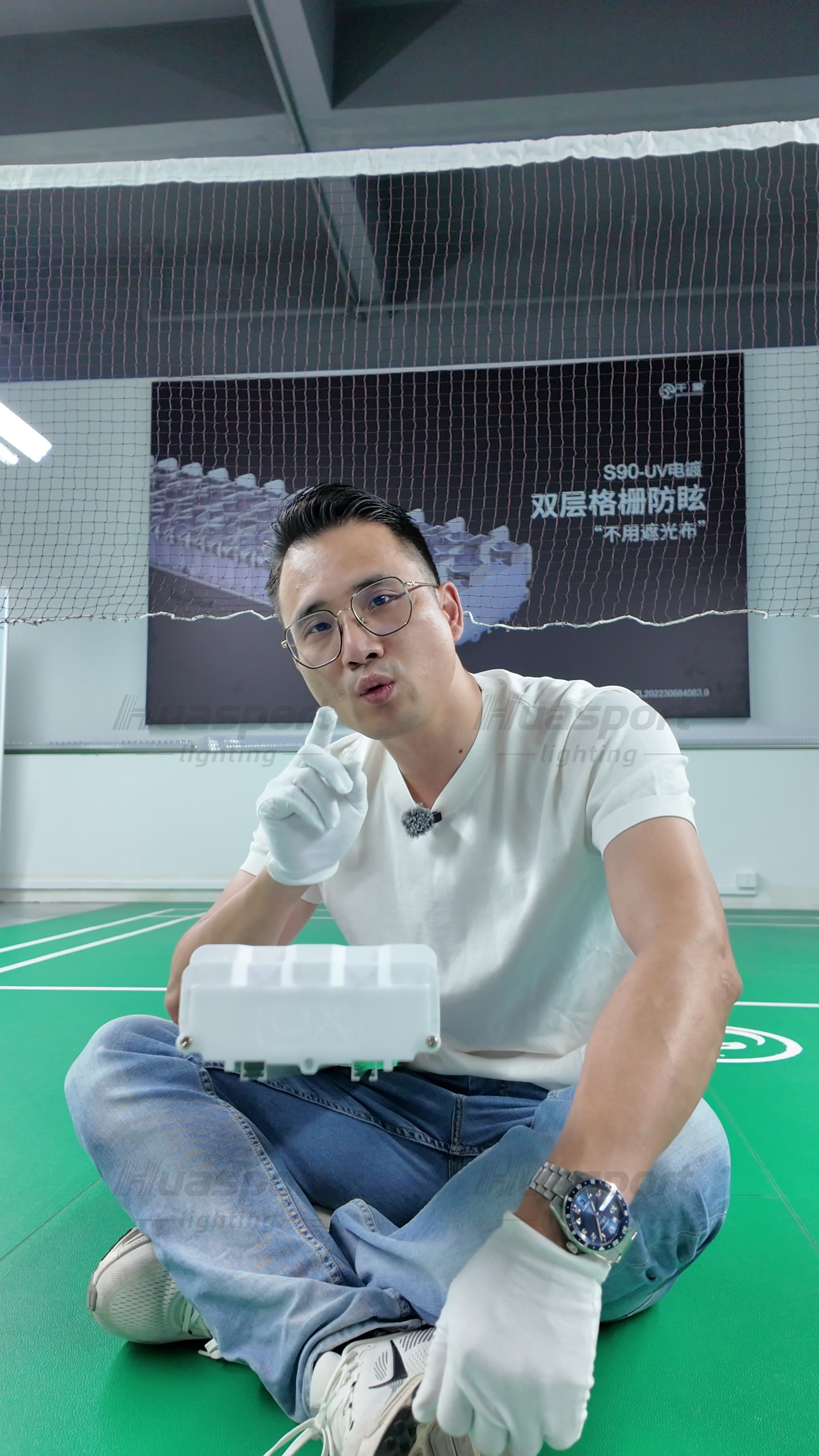 Indoor court view from the video showing why player-angle glare control matters before power reduction.