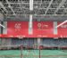 S70 anti-glare badminton court lighting in a multi-court hall with long light rows above the court