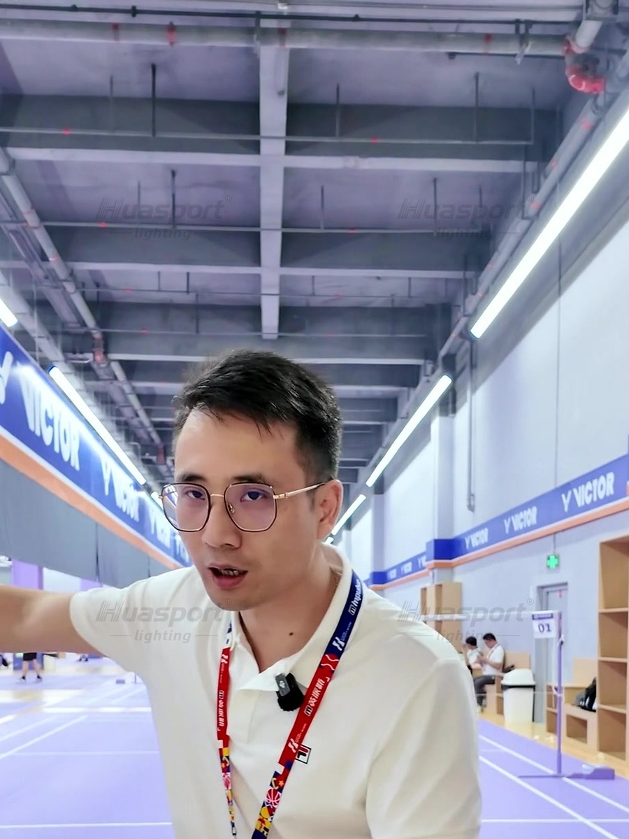T-shaped badminton hall video frame explaining court-to-court light spill and uneven brightness