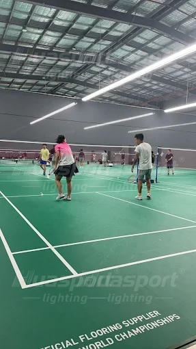 Australia badminton hall lighting reference showing player stance under long-bar rows